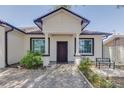 Inviting front entrance with tiled walkway, front bench, and manicured landscaping at 1150 7Th Ne Ave, Largo, FL 33770