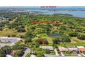 Aerial view of the home with lush greenery and a pond. Conveniently located near the Gulf of Mexico at 12020 66Th Ave, Seminole, FL 33772