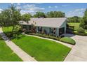 Charming home exterior with a lush green lawn, landscaping, an American flag, and a brick walkway at 12020 66Th Ave, Seminole, FL 33772