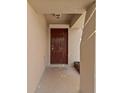 An inviting recessed entryway with a six-panel door and space for outdoor decor at 12620 Flatwood Creek Dr, Gibsonton, FL 33534
