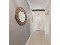 Hallway featuring modern decorative walls, recessed lighting, and light ceramic tile flooring at 12620 Flatwood Creek Dr, Gibsonton, FL 33534
