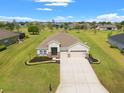 Expansive aerial shot of a single-story home with beautiful landscaping and well-maintained surroundings at 13953 Thoroughbred Dr, Dade City, FL 33525