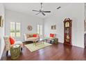 Bright living room with hardwood floors, plantation shutters, and a cozy seating arrangement at 13953 Thoroughbred Dr, Dade City, FL 33525