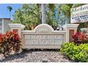 A monument sign for Beso Del Sol Resort with manicured landscaping and the Marker Tiki Bar event information at 1420 Bayshore Blvd # 409, Dunedin, FL 34698