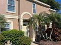 Inviting townhome with arched entry and well-maintained landscaping at 1512 Chateaux De Ville Ct, Clearwater, FL 33764