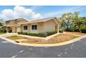 Inviting exterior of a one-story home with a well-maintained lawn, neatly trimmed bushes, and a neutral color palette at 1671 Cape Ann Ne Ave # 4, St Petersburg, FL 33702