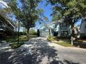 Charming blue two-story home with a well-manicured lawn and mature trees for shade at 17734 Long Ridge Rd, Tampa, FL 33647