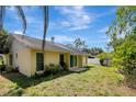 View of the backyard, with mature plants and exterior of home at 18426 Sterling Silver Cir, Lutz, FL 33549