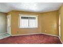 Spacious living room featuring carpet and a large window for natural light at 18426 Sterling Silver Cir, Lutz, FL 33549