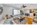 Open-concept living room featuring hardwood floors, neutral furniture, and an adjacent dining area for seamless entertaining at 2321 Wood Pointe Dr, Holiday, FL 34691