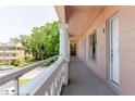 Long, light pink balcony showing a white pillar outside unit 63 at 2457 Ecuadorian Way # 63, Clearwater, FL 33763