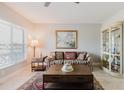 Bright living room with natural light, wood floors, a patterned couch, and stylish decor at 2457 Ecuadorian Way # 63, Clearwater, FL 33763