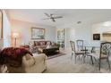 Inviting living room features a ceiling fan, light wood floors, and dining area at 2457 Ecuadorian Way # 63, Clearwater, FL 33763