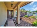 Covered front porch and entryway, complimented by tasteful landscaping and a stylish front door at 2597 Bramblewood E Dr, Clearwater, FL 33763