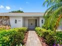 Inviting entrance with double doors, updated stonework, and manicured landscaping at 2850 Allapattah Dr, Clearwater, FL 33761