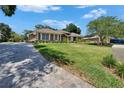 Beautiful home with lush lawn and a brick driveway leading to the house at 3060 Sutton Woods Dr, Plant City, FL 33566