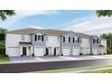 Newly constructed townhomes feature two-car garages, light paint, and nicely landscaped yard at 32429 Welling Blade Loop, Wesley Chapel, FL 33545
