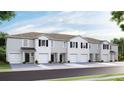 Newly constructed townhomes feature two-car garages, white paint, and nicely landscaped yard at 32429 Welling Blade Loop, Wesley Chapel, FL 33545