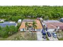 Lovely home features a tile roof and is surrounded by lush greenery and a peaceful waterway at 3301 Elkridge Dr, Holiday, FL 34691