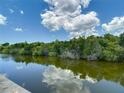 Scenic view of the calm waterway bordered by lush green trees reflecting on the water at 3301 Elkridge Dr, Holiday, FL 34691