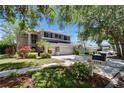 Two-story home featuring a three-car garage, landscaping, and mailbox at 3314 Cypress Landing Dr, Valrico, FL 33596