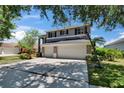 Charming home with three-car garage, large driveway, and a basketball hoop at 3314 Cypress Landing Dr, Valrico, FL 33596