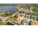 Aerial view of home on canal with lush landscaping and a waterway view at 339 Manatee Ln, Tarpon Springs, FL 34689