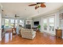 Cozy living room featuring a fireplace, wood floors, and lots of natural light at 339 Manatee Ln, Tarpon Springs, FL 34689