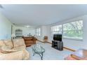 Bright living room with large windows, comfortable seating, and neutral carpet at 37348 Tucker Rd, Zephyrhills, FL 33541
