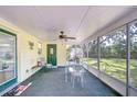 Relaxing screened porch with outdoor seating and a view of the backyard at 37348 Tucker Rd, Zephyrhills, FL 33541