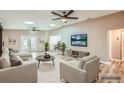 Bright living room with skylights, ceiling fans, and French doors to the backyard at 4018 Indianapolis Ne St, St Petersburg, FL 33703