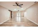 Spacious living room features wood-look floors, skylights, a ceiling fan, and rustic sliding barn door at 4018 Indianapolis Ne St, St Petersburg, FL 33703
