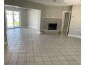 Spacious living room with tiled floors, a fireplace, and sliding glass doors to the backyard at 419 12Th Ave, Indian Rocks Beach, FL 33785