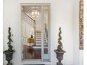 Inviting entryway featuring a view of the staircase and decorative plants at 4204 W San Juan St, Tampa, FL 33629