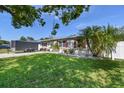 Single-story home showcasing well-maintained lawn, plants, and white rock landscaping at 8431 52Nd N Way, Pinellas Park, FL 33781