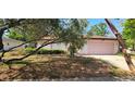 Charming single-story home with a well-maintained front yard and a two car garage, offering curb appeal at 8623 Stonehedge Way, Hudson, FL 34667