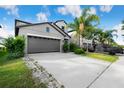 Home with a two-car garage and manicured front lawn with a covered vehicle in the driveway at 9617 Channing Hill Dr Dr, Ruskin, FL 33573