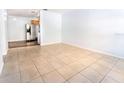 Bright living room with tile flooring next to kitchen with stainless steel appliances at 1021 Apollo Beach Blvd # 6, Apollo Beach, FL 33572