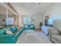 Bright living area featuring vaulted ceilings, large mirror, and comfortable seating at 1034 Mandarin Dr, Holiday, FL 34691