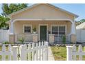Inviting single-story home with a cozy front porch and a classic white picket fence at 1050 22Nd N Ave, St Petersburg, FL 33704