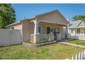 A quaint single-story home with a covered front porch and white picket fence at 1050 22Nd N Ave, St Petersburg, FL 33704