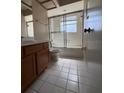 Bathroom featuring tile flooring, toilet, and a shower/tub with sliding glass doors at 114 Clays Trl # 114, Oldsmar, FL 34677