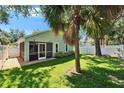 Well-maintained backyard featuring a screened in patio with a privacy fence at 11932 Whisper Creek Dr, Riverview, FL 33569