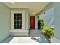 Entrance featuring a vibrant red door with an oval window, offering a pop of color at 11932 Whisper Creek Dr, Riverview, FL 33569