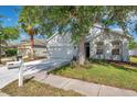 Attractive home with a neat lawn, mature tree, and a two-car attached garage at 12351 Ridgedale Dr, Hudson, FL 34669