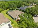 Aerial view of the house showing the surrounding trees and screened pool in the backyard at 19808 Sunsplash Ln, Lutz, FL 33558