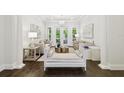Bright living room with hardwood floors, decorative columns, and French doors offers a sophisticated space at 2604 S Bryant Cir, Tampa, FL 33629