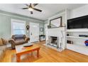Bright living room with hardwood floors, a fireplace, and classic white trim at 2638 Burlington N Ave, St Petersburg, FL 33713