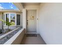 Inviting entryway with a charming 'hello sunshine' sign, decorative plants, and a stylish doormat near bay window at 3074 Dothan Ave, Spring Hill, FL 34609