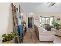 Bright living room features wood floors, comfortable seating, and a decorative ladder with blanket display at 3074 Dothan Ave, Spring Hill, FL 34609